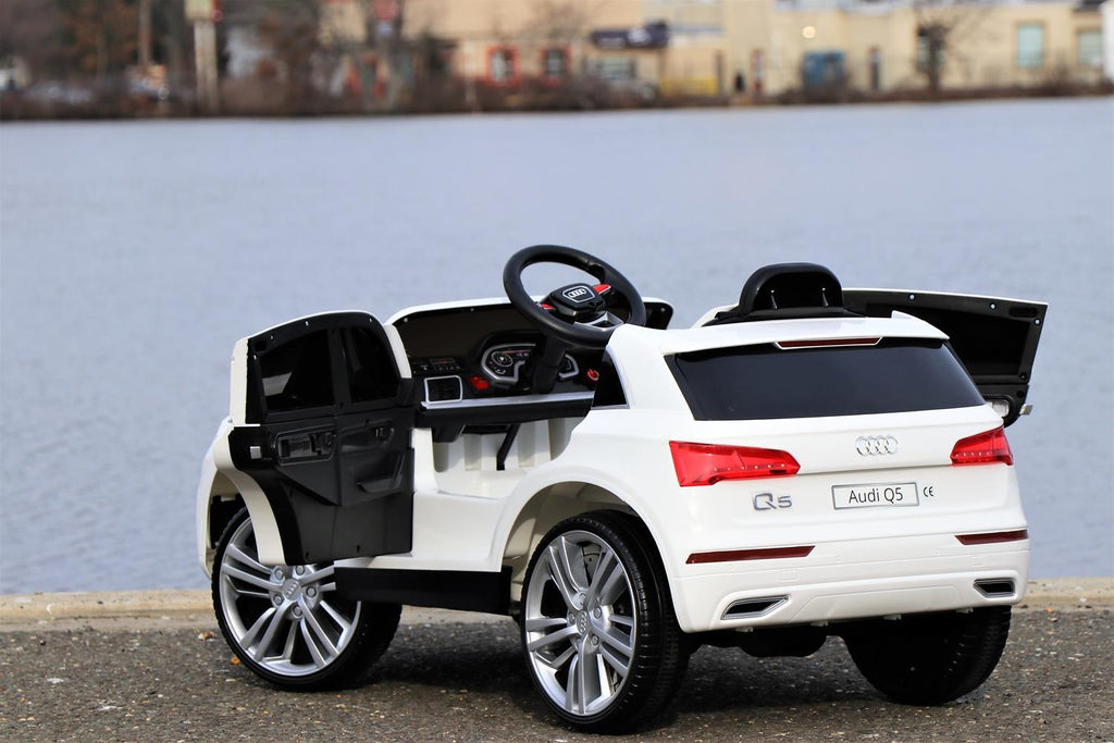 First Drive Audi Q5 White 12v Kids Cars - Dual Motor Electric Power Ride On Car with Remote, MP3, Aux Cord, Led Headlights and Rear Lights, and Premium Wheels