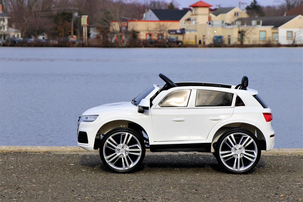 First Drive Audi Q5 White 12v Kids Cars - Dual Motor Electric Power Ride On Car with Remote, MP3, Aux Cord, Led Headlights and Rear Lights, and Premium Wheels